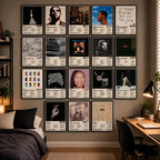 A cozy bedroom with 18 framed Drake album cover posters arranged in a gallery wall above a bed and beside a desk.