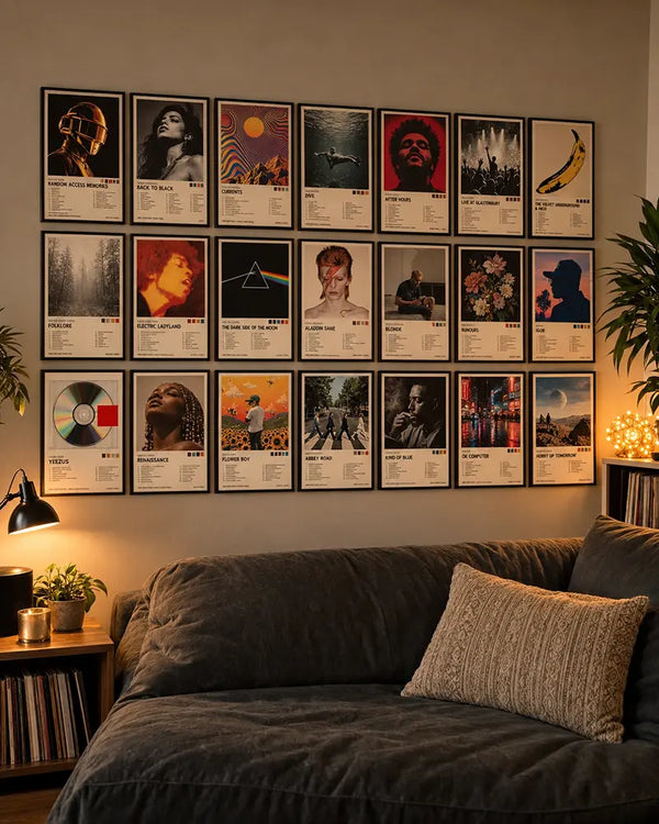 Professional living room featuring 21 framed album cover posters arranged above a charcoal sofa, styled with warm ambient lighting, indoor plants and vinyl records.