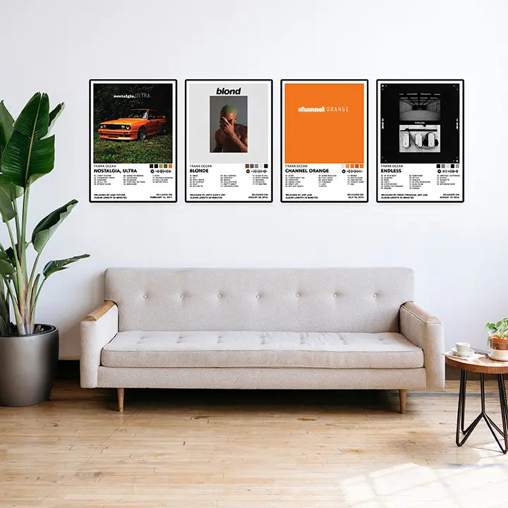 Four framed Frank Ocean album cover posters displayed in a row above a sofa in a bright living room.