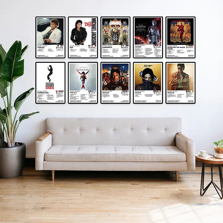 Ten framed Michael Jackson album cover posters arranged in two rows above a sofa in a bright living room.