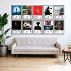 Ten framed NBA YoungBoy album cover posters arranged above a sofa in a bright living room.