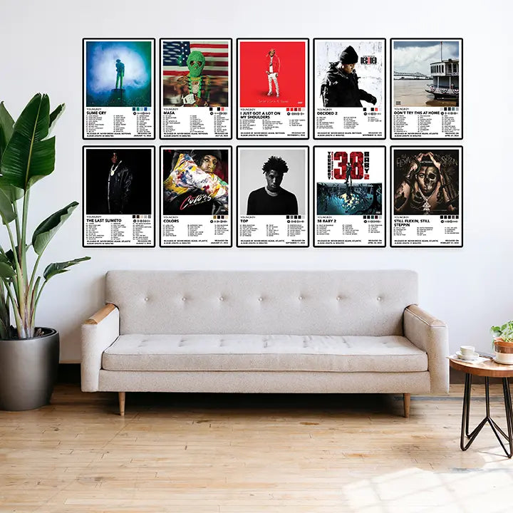 A selection of NBA YoungBoy posters arranged in two rows above a living room sofa.