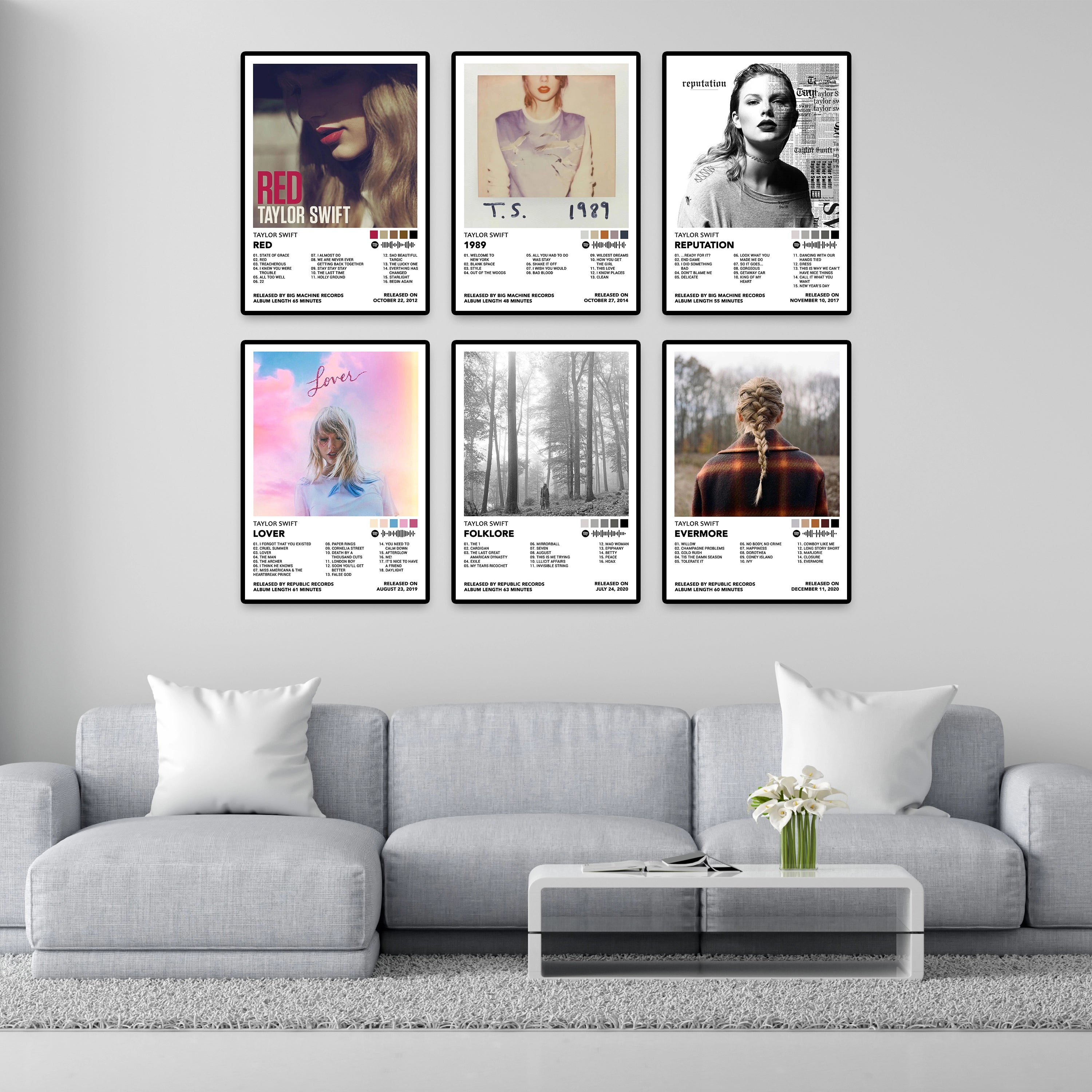 Three Taylor Swift album cover posters displayed on a modern wall above an acoustic guitar and chair. Features Taylor Swift, Fearless, and Speak Now album posters printed on premium 260 GSM glossy cardstock. Perfect Swiftie bedroom decor, dorm room wall art, music room decoration, and Taylor Swift fan gifts.