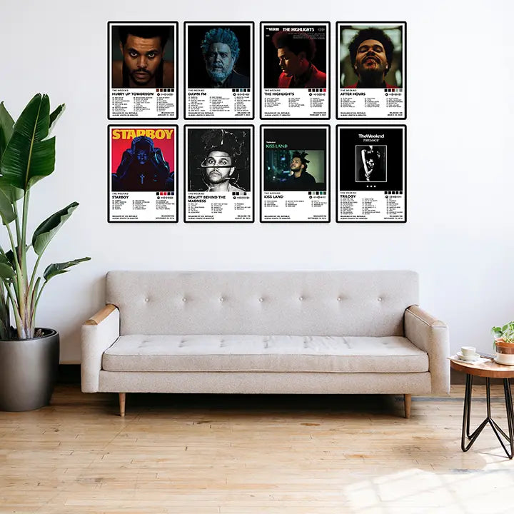 Eight framed The Weeknd album cover posters displayed above a sofa in a bright living room.